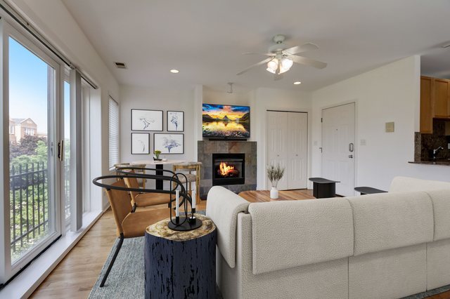 2457 West Harrison Street, Unit 3 Chicago, IL 60612 - Photo 2 of 20 a living room with furniture a fireplace and a flat screen tv