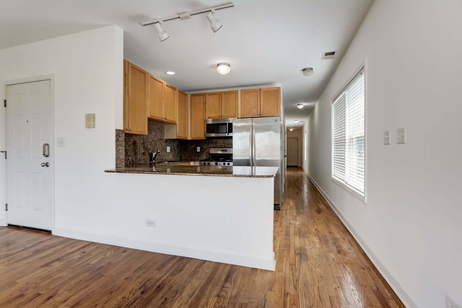 2457 West Harrison Street, Unit 3 Chicago, IL 60612 - Photo 4 of 20 a kitchen with stainless steel appliances a refrigerator sink and microwave