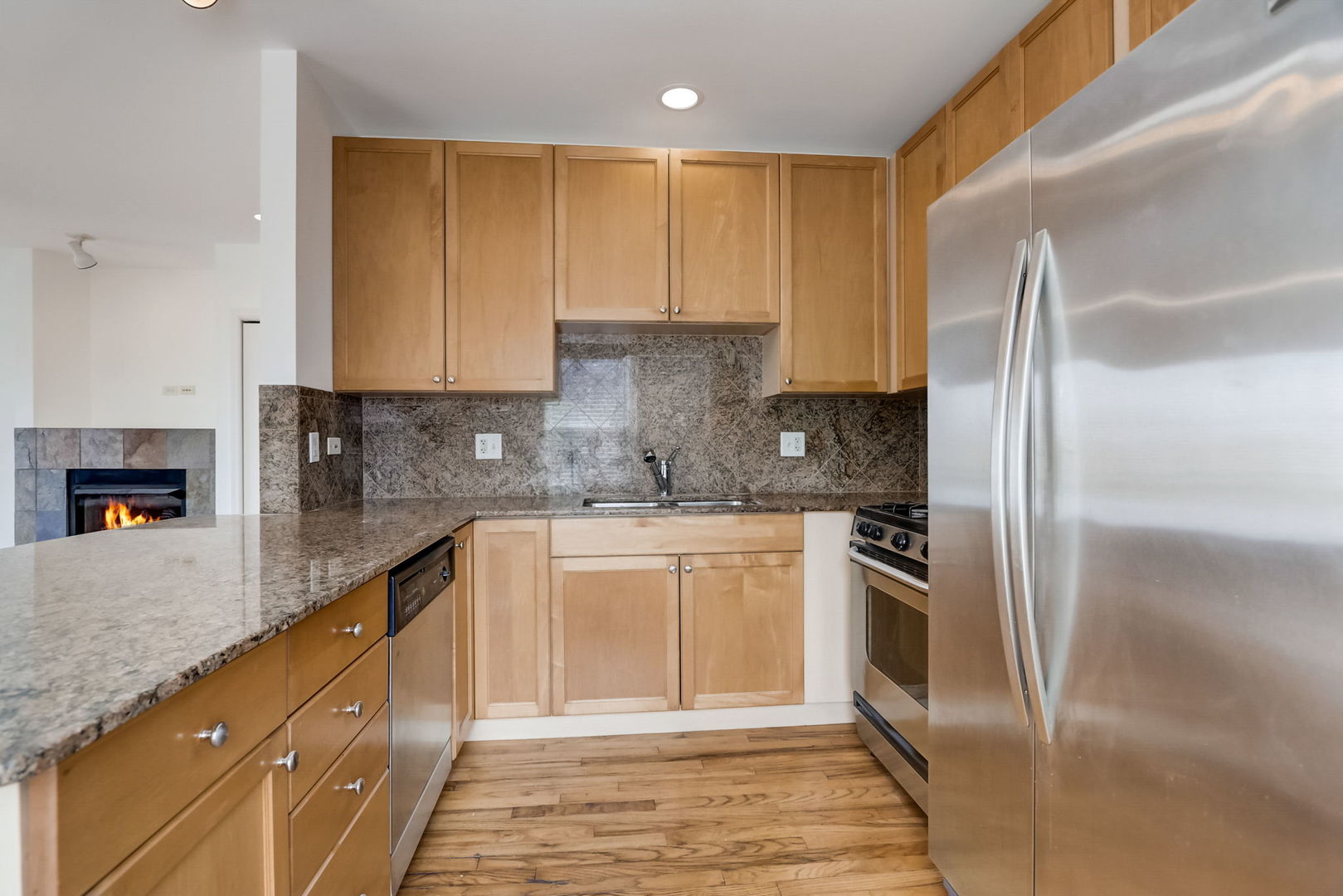 2457 West Harrison Street, Unit 3 Chicago, IL 60612 - Photo 6 of 20 a kitchen with stainless steel appliances granite countertop a stove a sink and a refrigerator