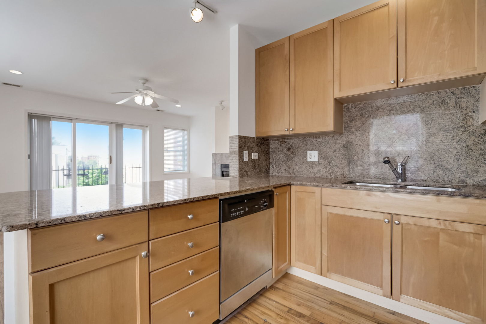 2457 West Harrison Street, Unit 3 Chicago, IL 60612 - Photo 7 of 20 a kitchen with granite countertop white cabinets and a sink