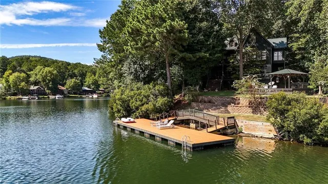 a living room with patio furniture and a chandelier