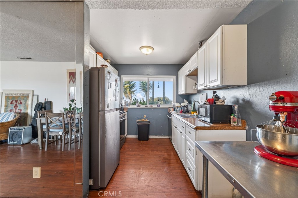 1688 Harding Street Seaside, CA 93955 - Photo 11 of 37 a kitchen with lots of counter top space and stainless steel appliances