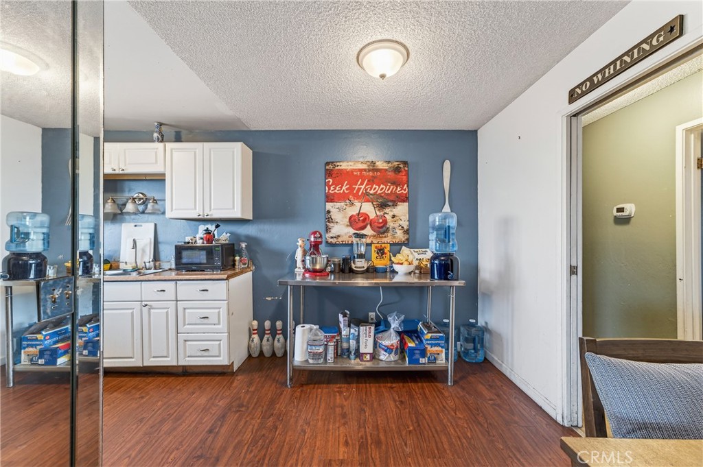 1688 Harding Street Seaside, CA 93955 - Photo 12 of 37 a kitchen that has a lot of cabinets and wooden floor