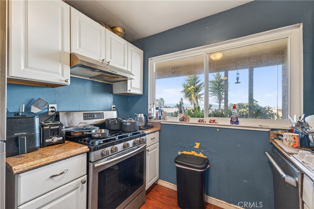 1688 Harding Street Seaside, CA 93955 - Photo 13 of 37 a kitchen with stainless steel appliances granite countertop a stove a sink and a microwave