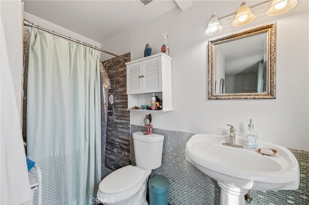 1688 Harding Street Seaside, CA 93955 - Photo 20 of 37 a bathroom with a toilet sink and mirror