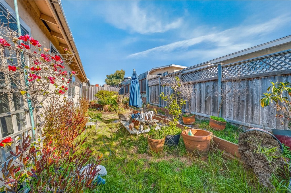 1688 Harding Street Seaside, CA 93955 - Photo 22 of 37 a backyard of a house with lots of green space and fountain