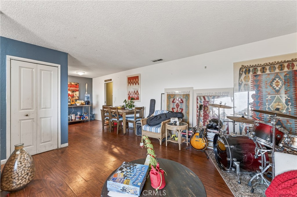 1688 Harding Street Seaside, CA 93955 - Photo 7 of 37 a living room with furniture and a dining table with wooden floor