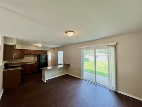 829 Princeton Avenue Matteson, IL 60443 - Photo 11 of 20 a living room with stainless steel appliances granite countertop furniture and a wooden floor