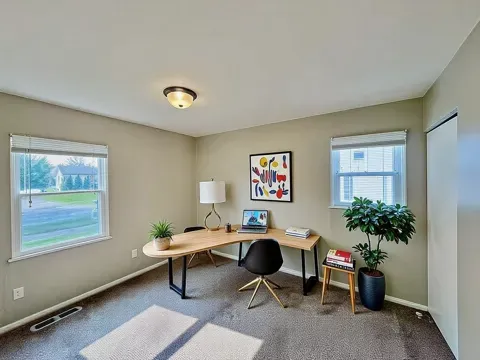 a work room with furniture potted plant and a window