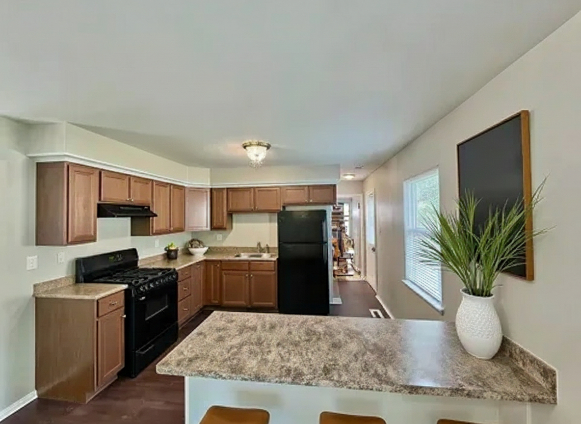 829 Princeton Avenue Matteson, IL 60443 - Photo 6 of 20 a kitchen with stainless steel appliances kitchen island granite countertop a refrigerator a stove top oven a sink and wooden floor