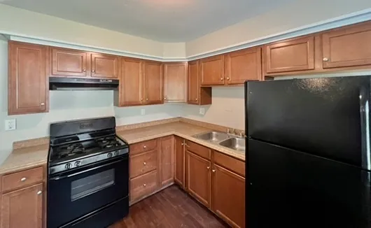 a kitchen with granite countertop stainless steel appliances and wooden cabinets