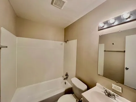 a bathroom with a tub and shower