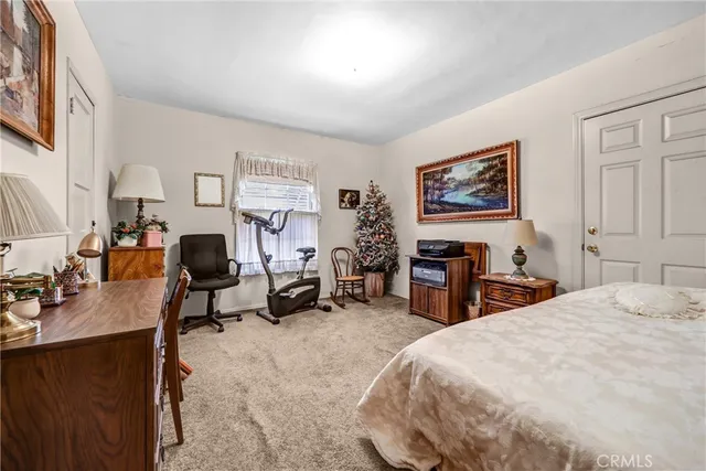 a bed room with a bed a desk and chair