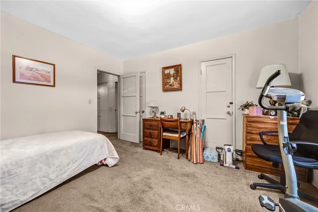 a bedroom with a bed and a desk