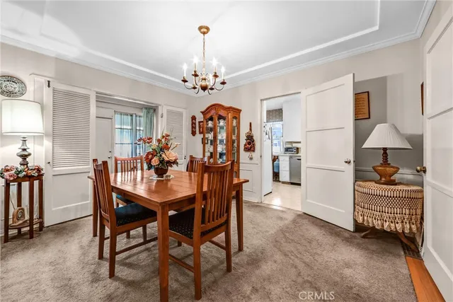 a view of a dining room with furniture and chandelier