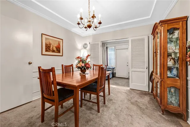 a view of a dining room with furniture and chandelier
