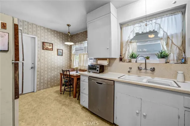 a kitchen with a sink cabinets and window