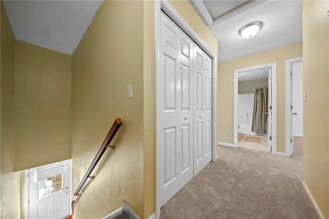 a view of a hallway with wooden floor and entryway