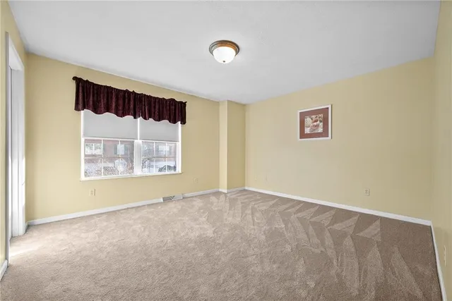 an empty room with windows and door