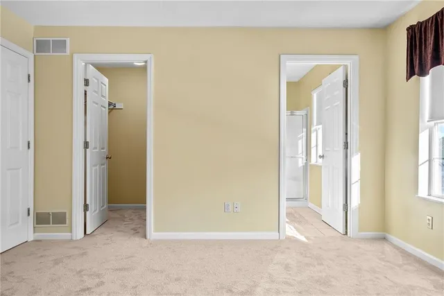 an empty room with windows and closet
