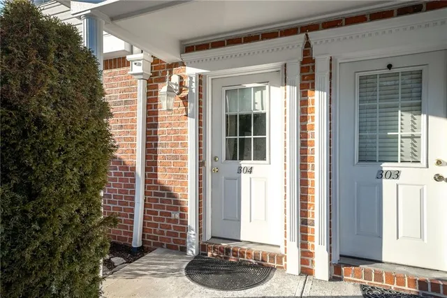 a balcony with table and chairs and potted plants