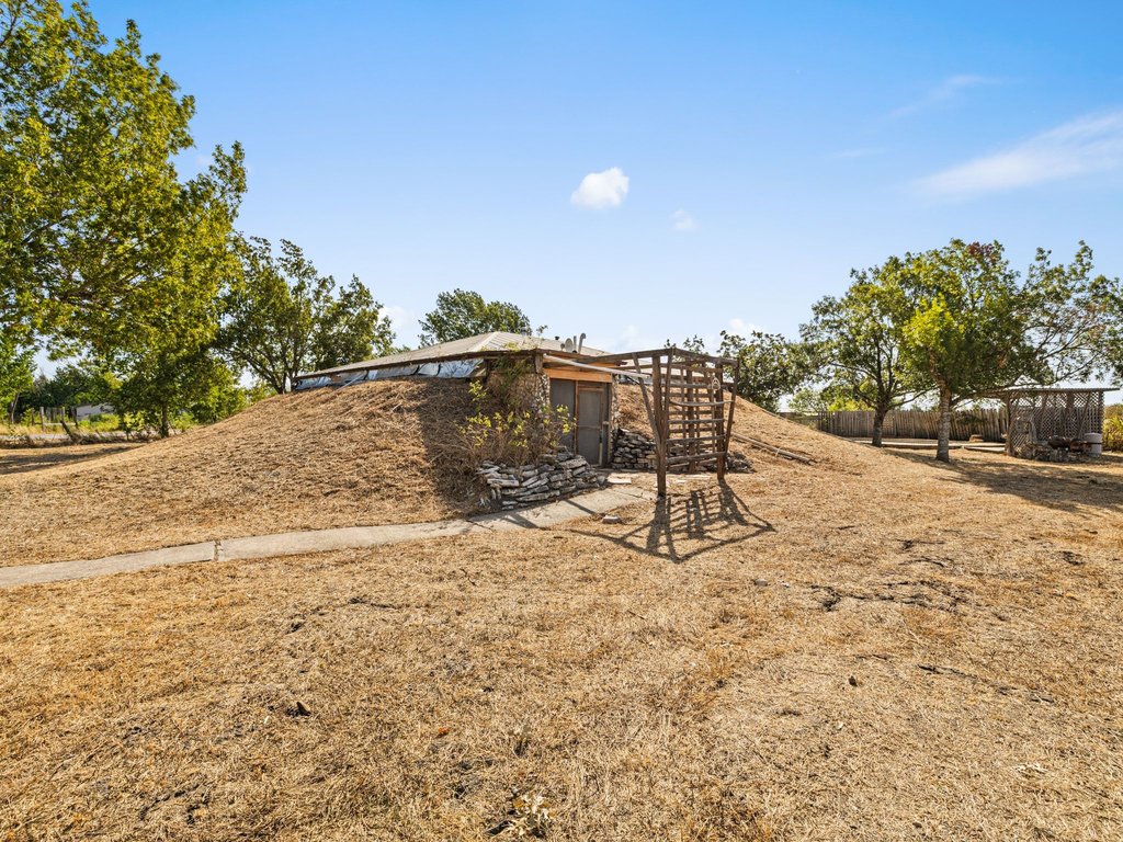 20416 Wilson Road Coupland, TX 78615 - Photo 29 of 39 Unique earth-sheltered architectural design integrates seamlessly into the surrounding natural landscape.