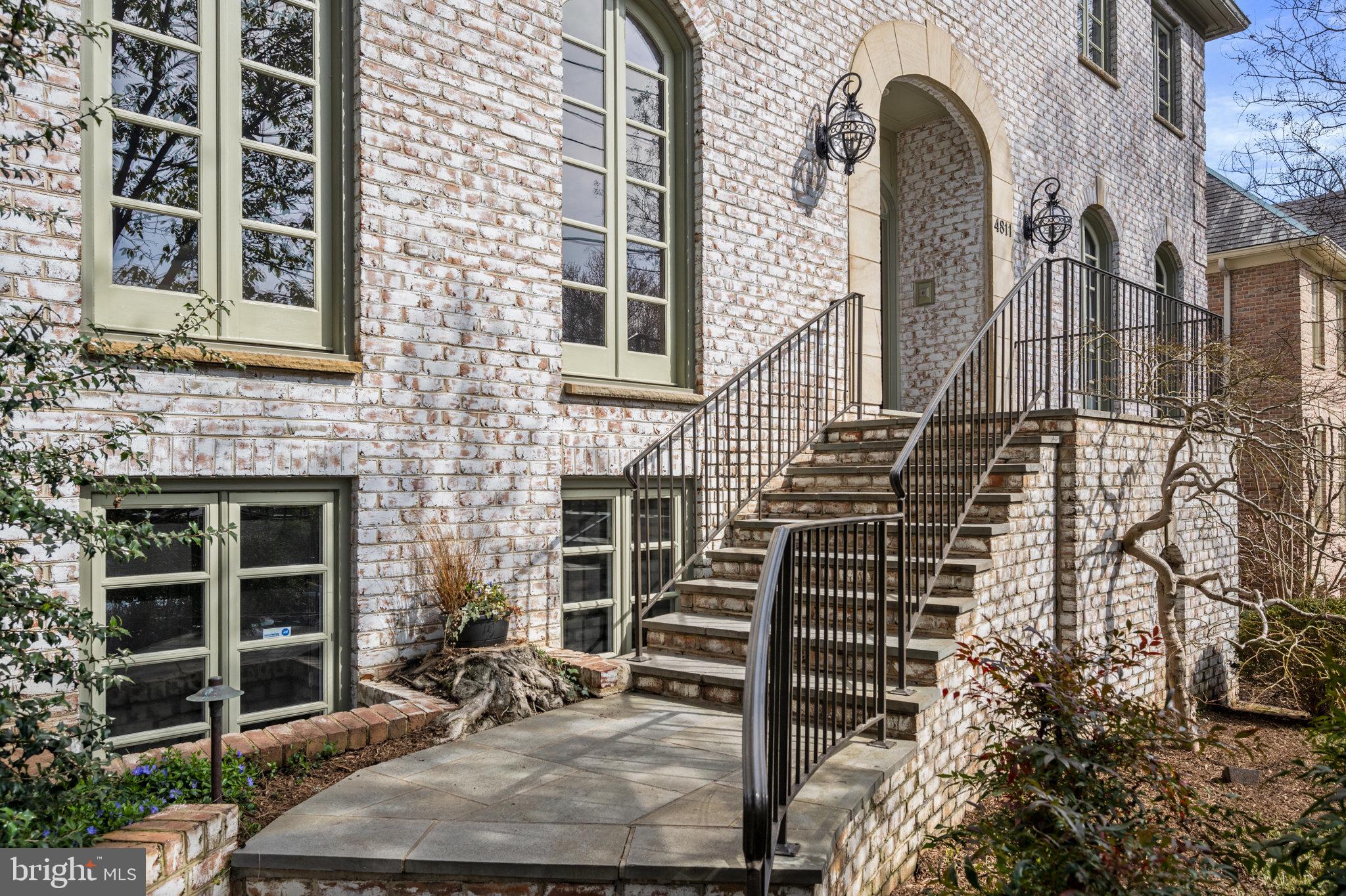 Whitewashed Brick Colonial with Limestone Accents
