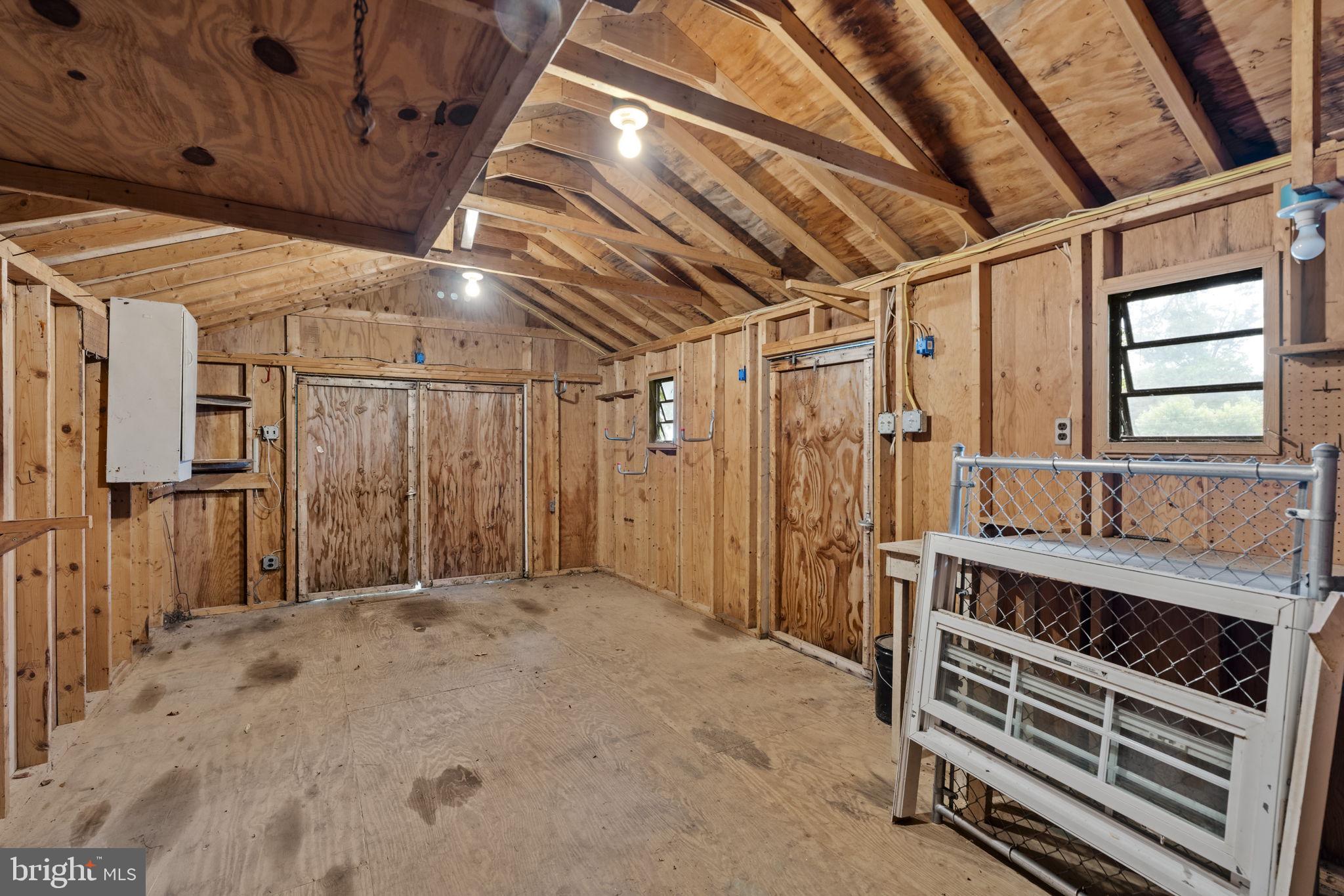 65 Compass Road Parkesburg, PA 19365 - Photo 57 of 61 Spacious wooden shed with rustic charm.
