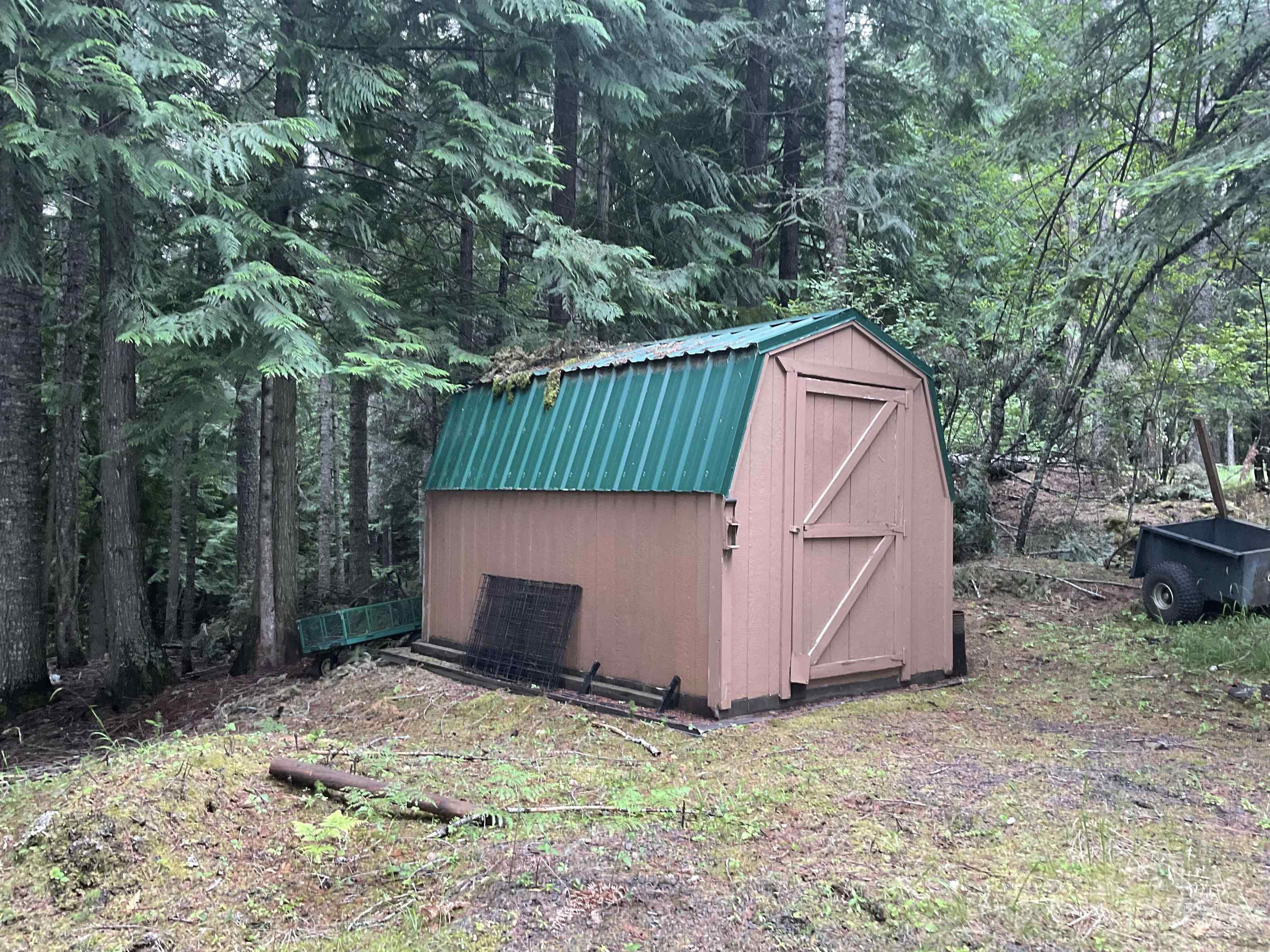 6125 Freeman Creek Road Lenore, ID 83541 - Photo 43 of 44 Freestanding storage shed with a gambrel roof and a green metal finish