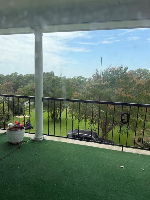 83 Bass Road Pottsboro, TX 75076 - Photo 6 of 31 Balcony with green turf flooring and decorative black metal railing