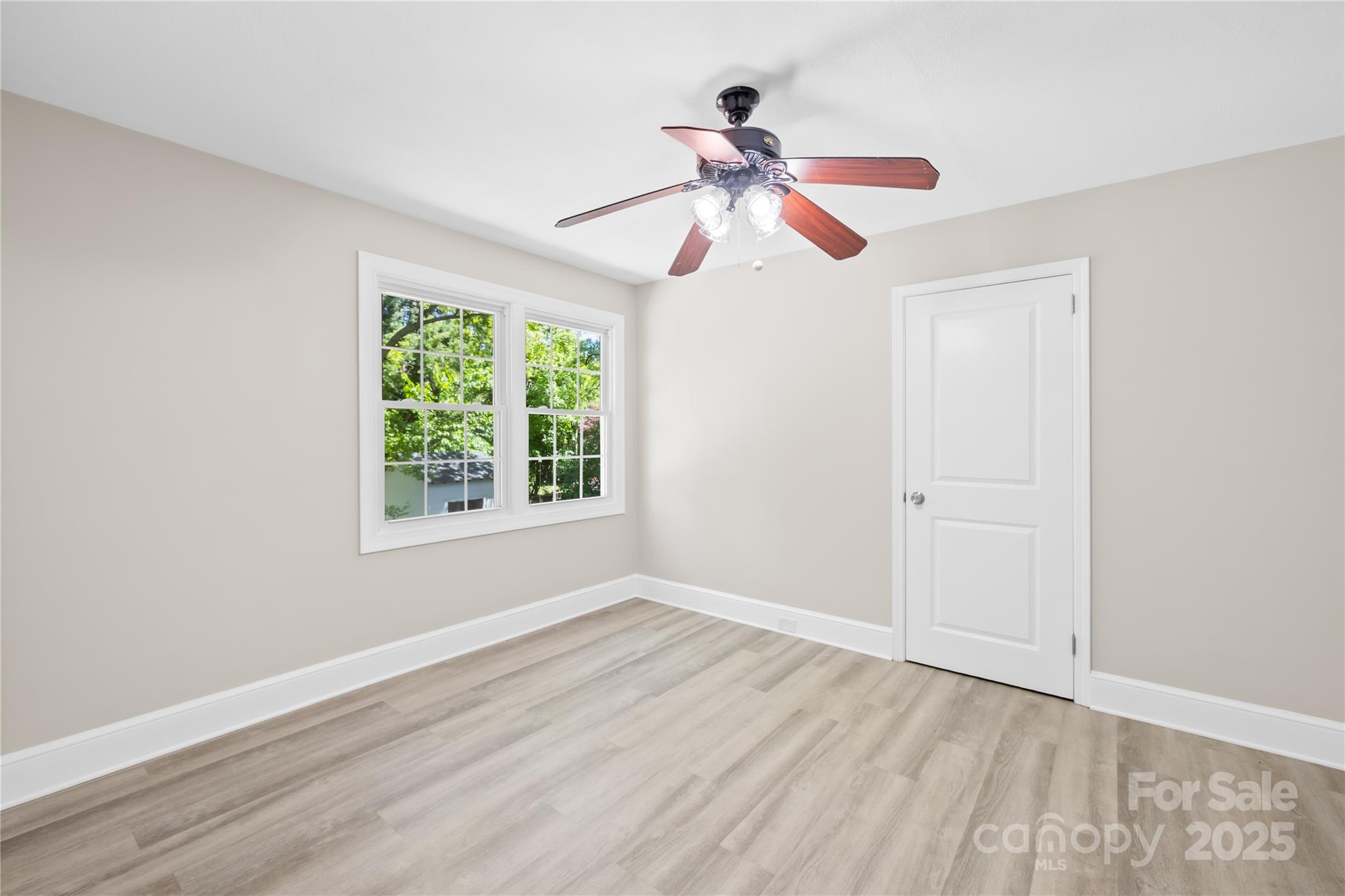 6012 Tuckaseegee Road Charlotte, NC 28208 - Photo 17 of 30 a view of empty room with wooden floor and fan