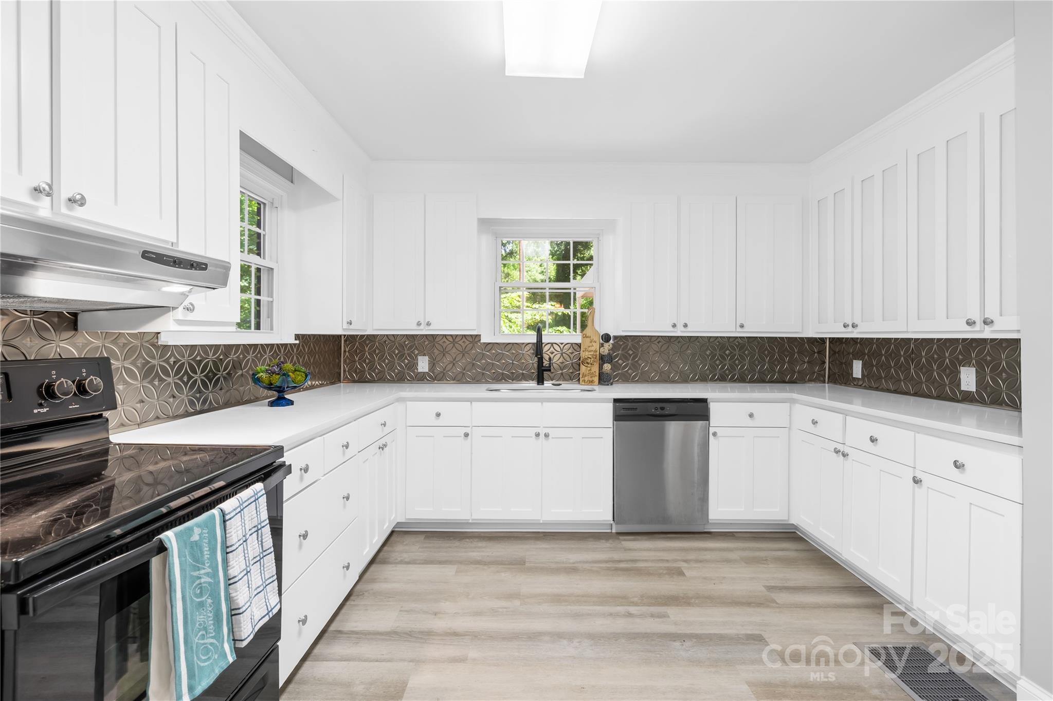 6012 Tuckaseegee Road Charlotte, NC 28208 - Photo 3 of 30 a kitchen with granite countertop white cabinets and appliances