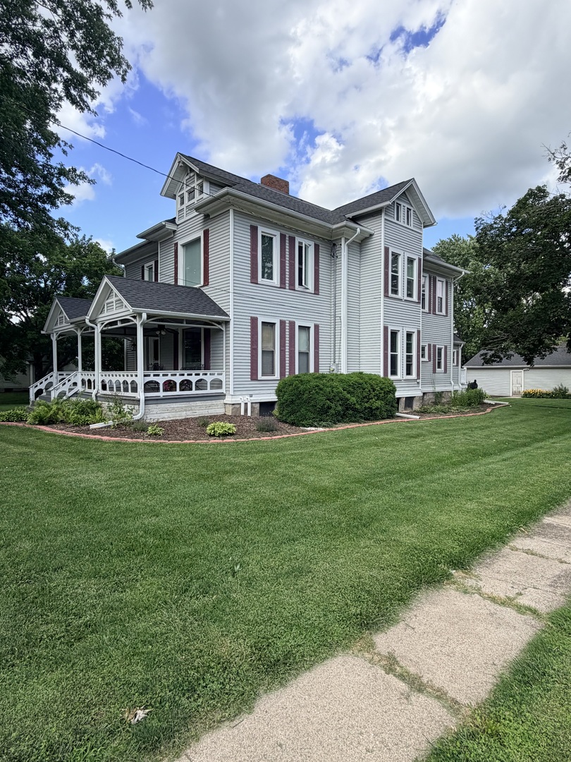 340 South Main Street Sheffield, IL 61361 - Photo 2 of 32 a front view of a house with a garden and trees