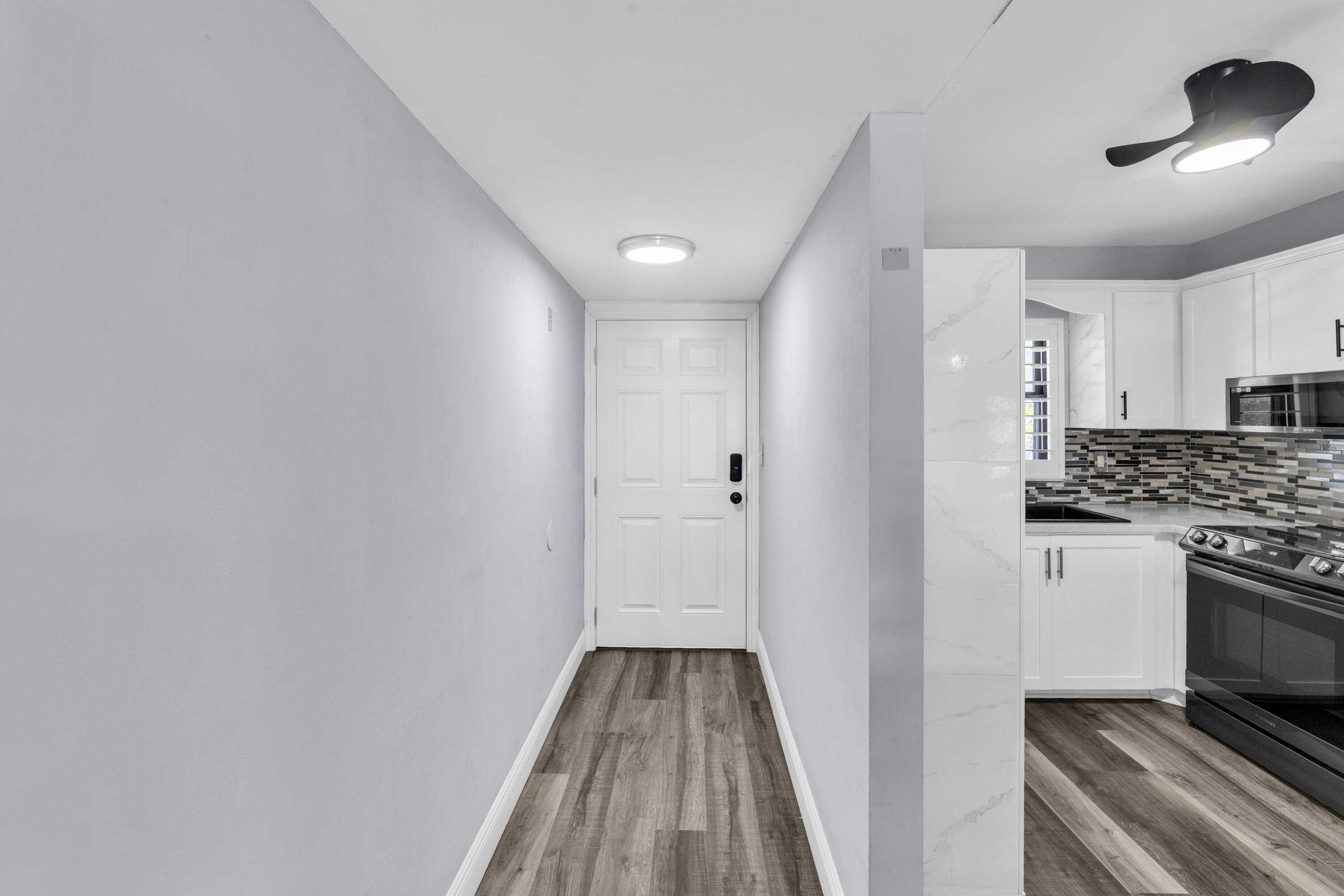 1901 Woolbright Road, Unit A203 Boynton Beach, FL 33426 - Photo 25 of 32 FRONT DOOR ENTRANCE WAY AND KITCHEN AREA