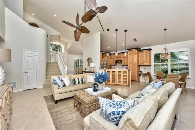 a living room with furniture ceiling fan and a rug