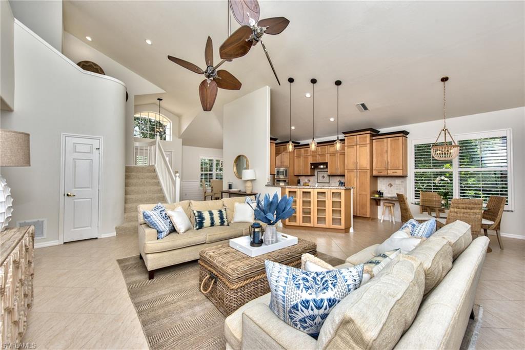 1705 Marsh Run Naples, FL 34109 - Photo 1 of 40 a living room with furniture ceiling fan and a rug