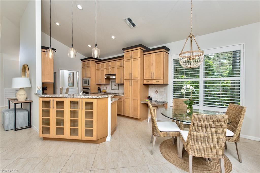 1705 Marsh Run Naples, FL 34109 - Photo 15 of 40 a large kitchen with a table and chairs