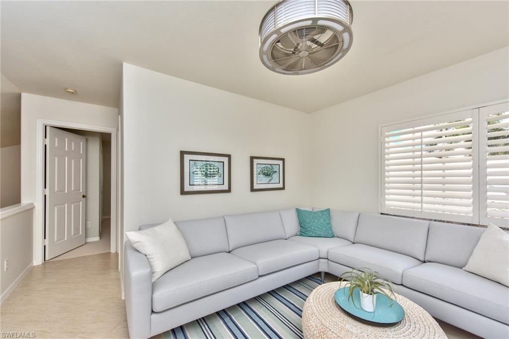 1705 Marsh Run Naples, FL 34109 - Photo 22 of 40 a living room with furniture a table and a window