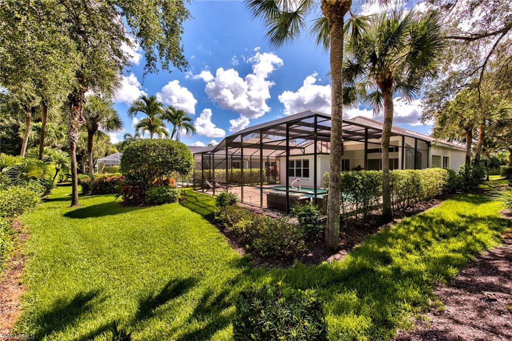 1705 Marsh Run Naples, FL 34109 - Photo 35 of 40 a view of a house with swimming pool next to a yard