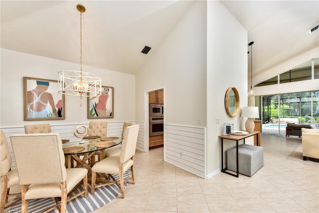 1705 Marsh Run Naples, FL 34109 - Photo 5 of 40 a dining room with furniture and a chandelier