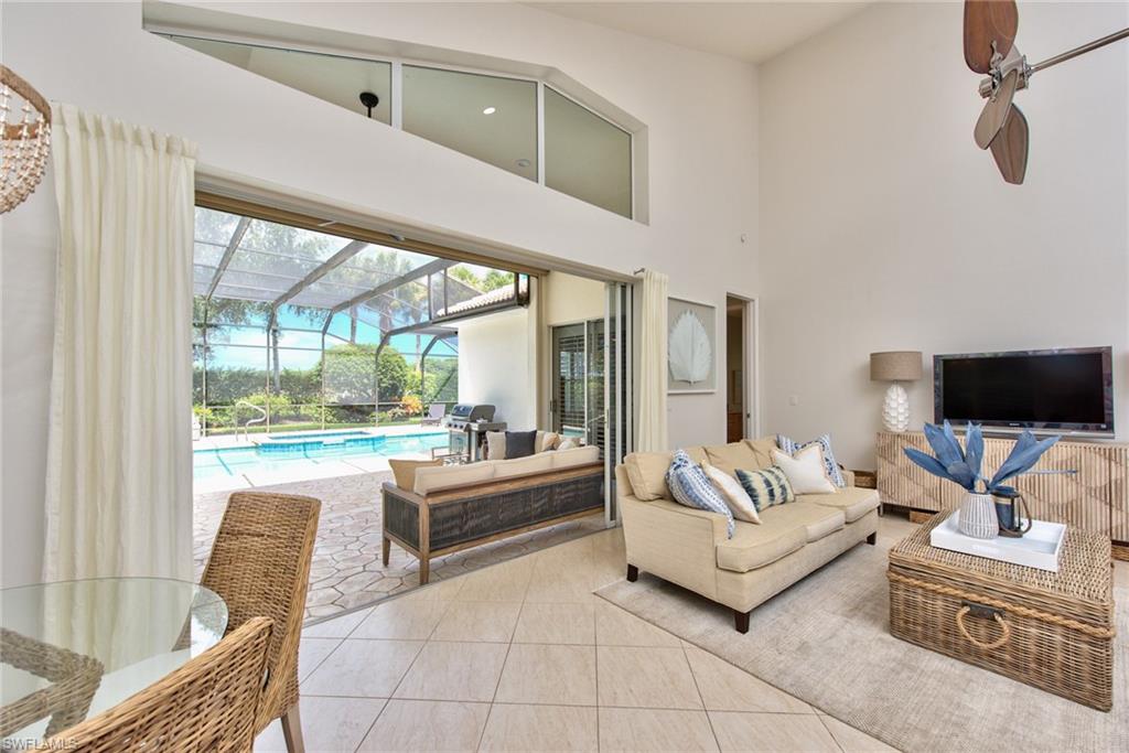1705 Marsh Run Naples, FL 34109 - Photo 7 of 40 a living room with furniture and a flat screen tv
