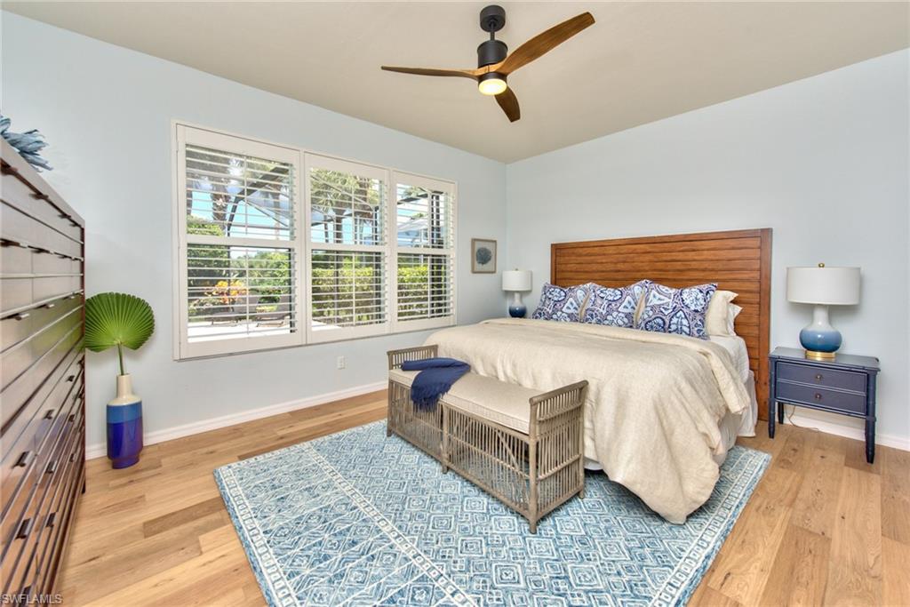 1705 Marsh Run Naples, FL 34109 - Photo 10 of 40 a bedroom with a bed a couch and a table