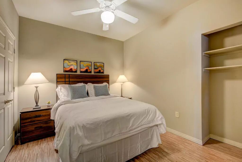 2515 Pearl Street, Unit 602 Austin, TX 78705 - Photo 2 of 5 a bedroom with a bed and wooden floor