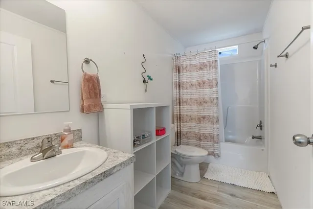 a bedroom with a bed cabinets and window