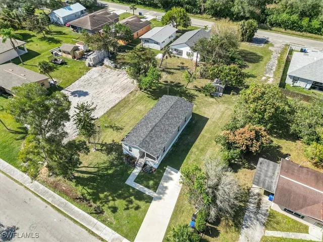 an aerial view of residential houses with outdoor space and swimming pool