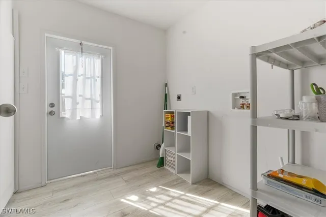 a view of a livingroom with wooden floor and a cabinet