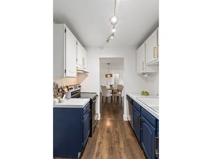 a view of a dining room with furniture wooden floor and a chandelier