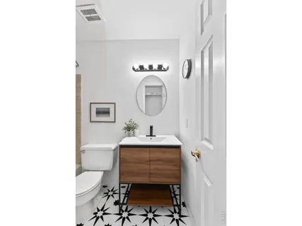 an empty room with wooden floor and ceiling fan