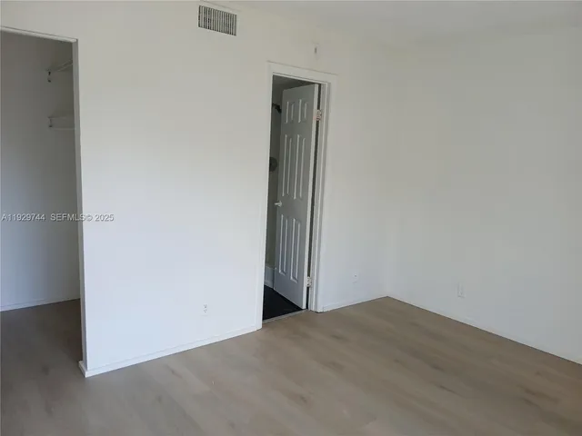an empty room with wooden floor
