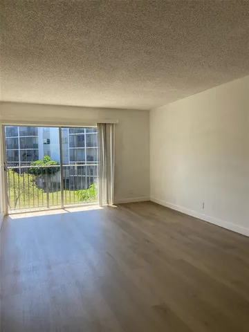 an empty room with a empty space and glass door